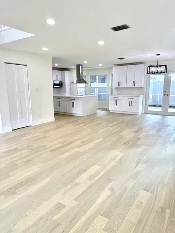 a view of a kitchen with refrigerator and cabinets