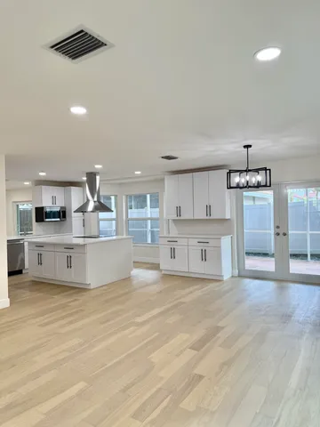 a view of kitchen with cabinets and wooden floor