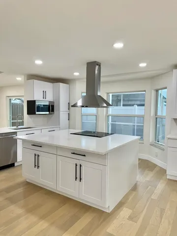 a kitchen with stainless steel appliances granite countertop a sink and cabinets