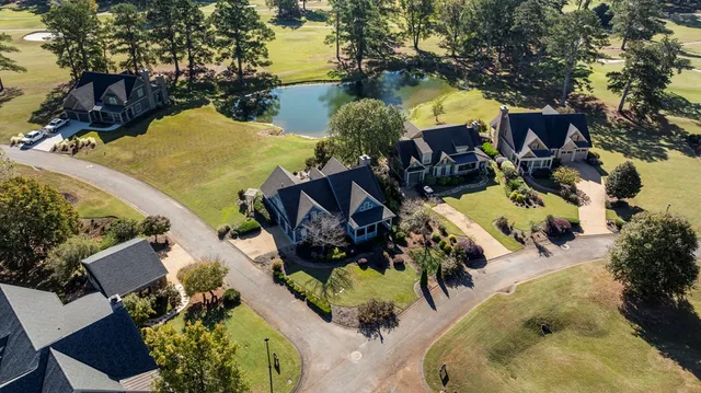 an aerial view of a house with a swimming pool and outdoor seating