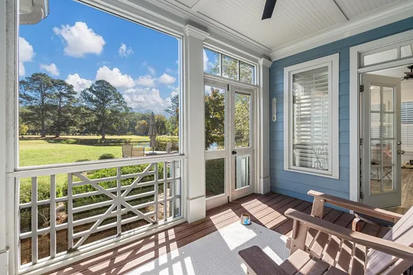 a view of a balcony with floor to ceiling windows with wooden floor