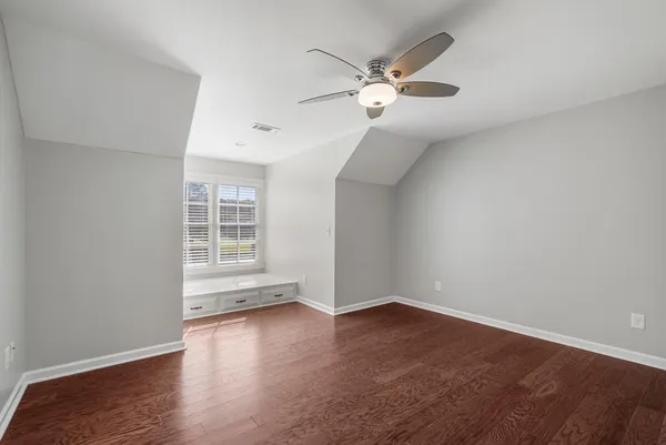 a spacious bedroom with a bed and a chandelier