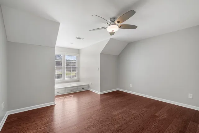 a spacious bedroom with a bed and a chandelier