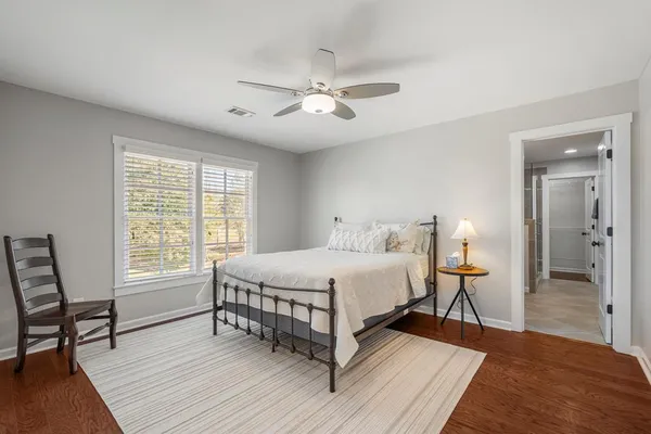 a bathroom with a sink a toilet a mirror and shower