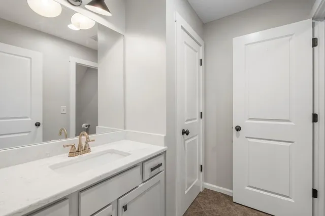 a bathroom with a sink a toilet and a window