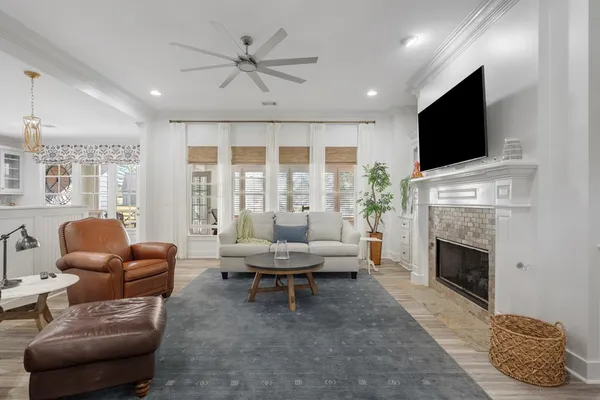 a living room with furniture a flat screen tv and a fireplace