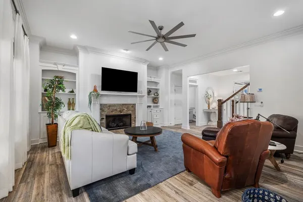 a living room with furniture a flat screen tv and a fireplace