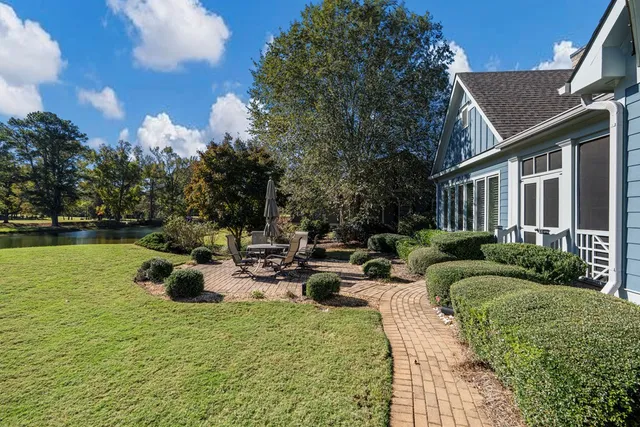 a view of a house with backyard and sitting area