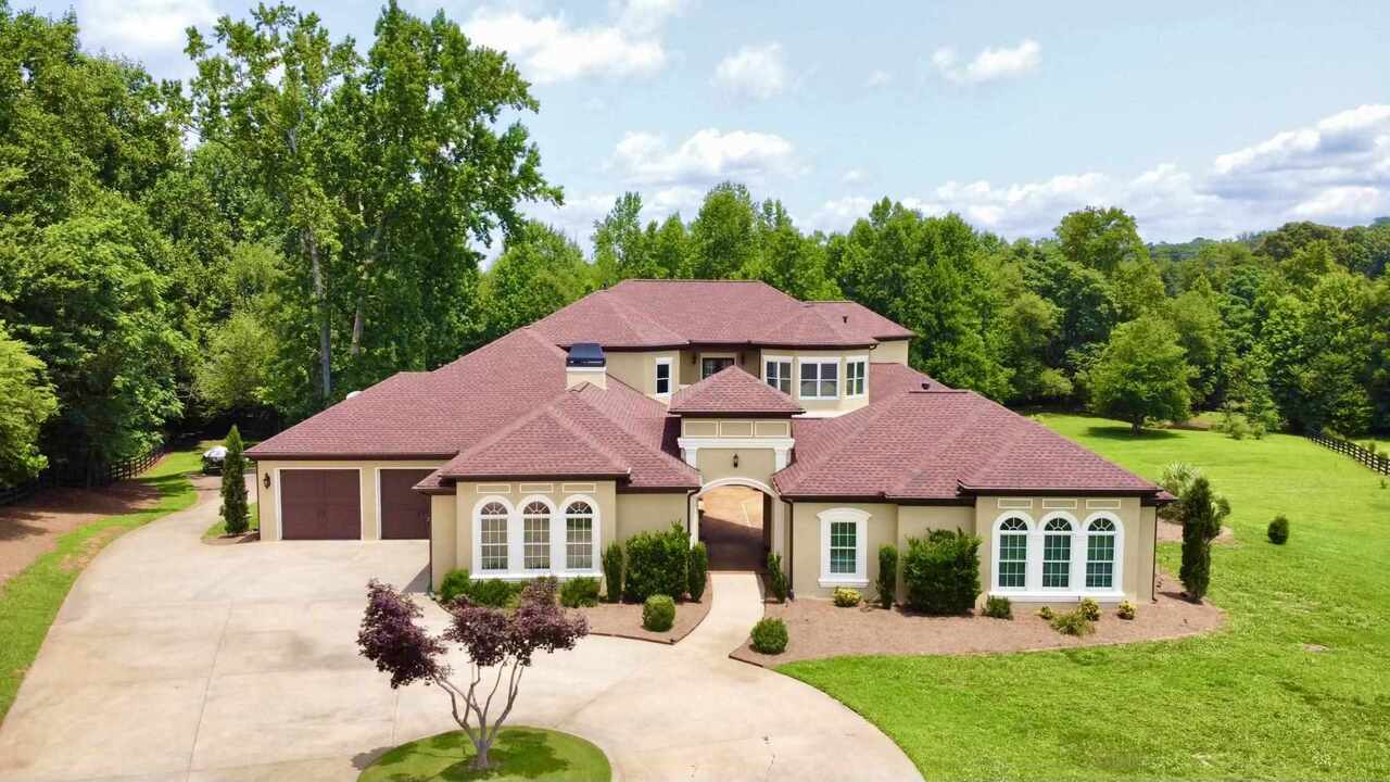 5249 Burma Road Cumming, GA 30041 - Photo 1 of 1 a front view of a house with garden