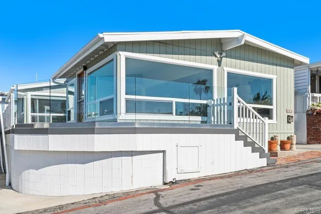 a balcony of a house with wooden floor and fence