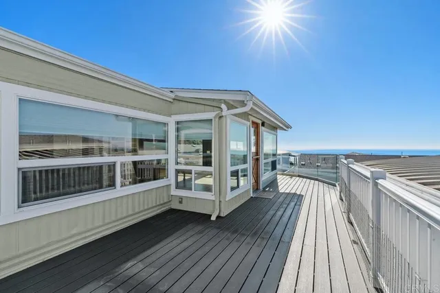 a view of a balcony with wooden floor