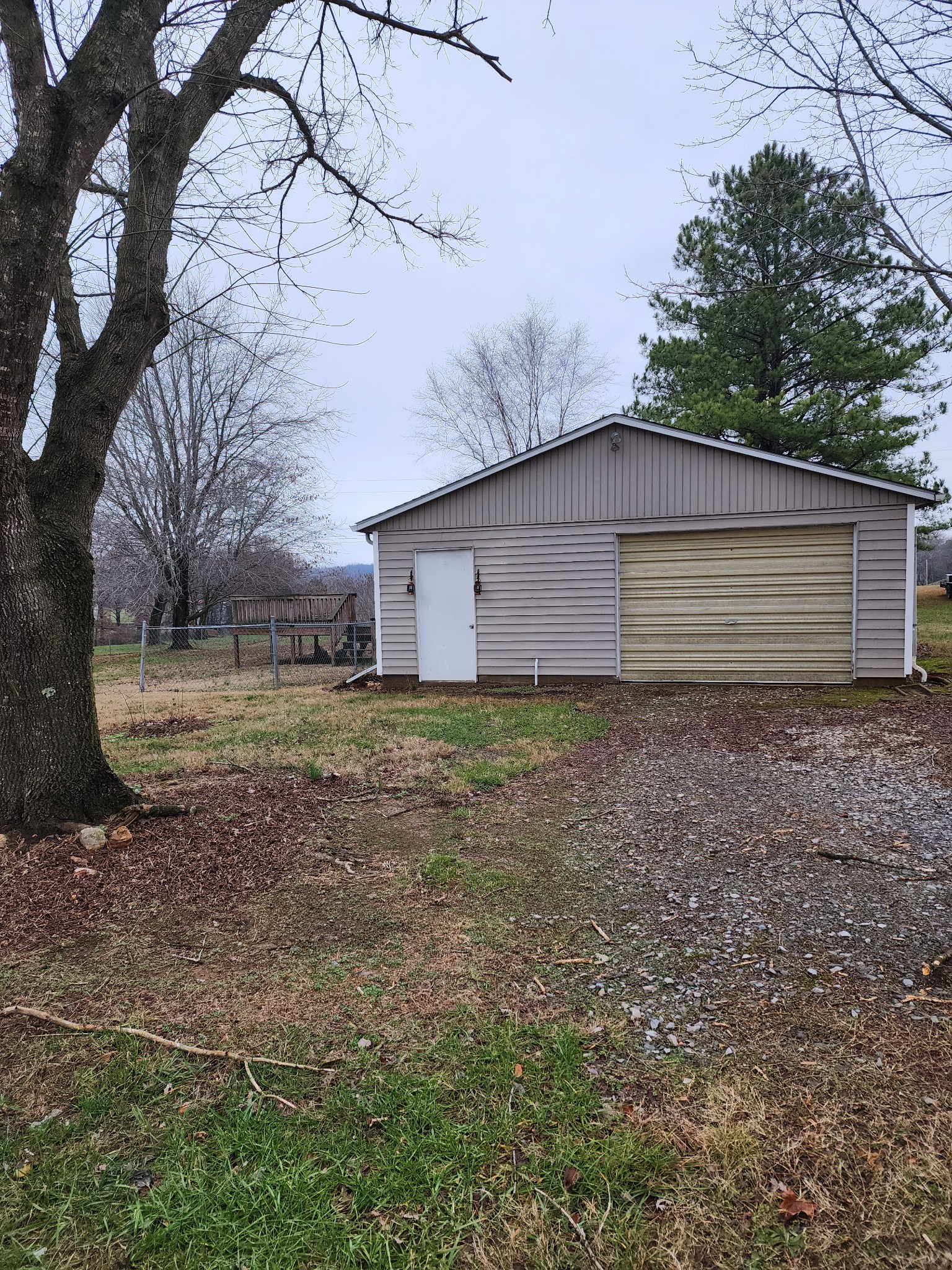 819 Branch Bend Road Clarksville, TN 37040 - Photo 2 of 24 a house that has a lot of plants and a large tree