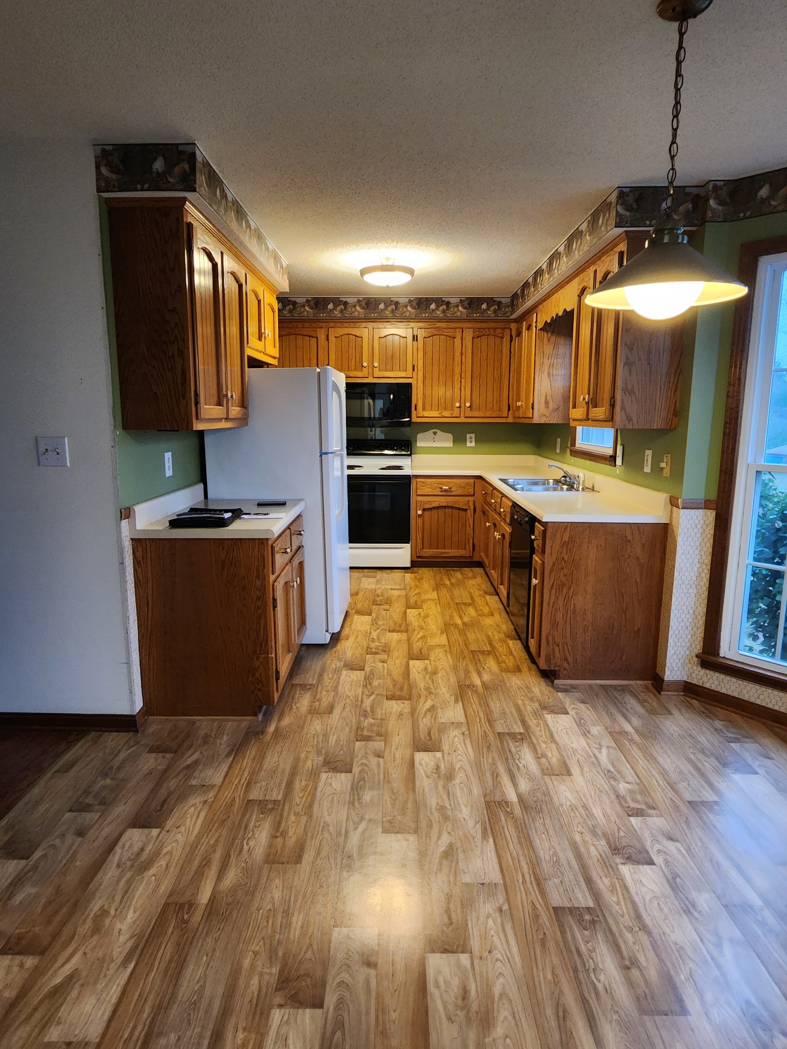 819 Branch Bend Road Clarksville, TN 37040 - Photo 9 of 24 a kitchen with stainless steel appliances granite countertop a sink a stove top oven a counter space and cabinets