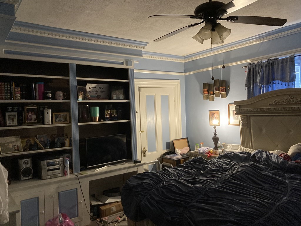 662 Main Street Haverhill, MA 01830 - Photo 9 of 23 a bedroom with a bed cabinets and a window