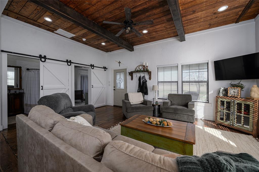 4597 West Line Road Whitesboro, TX 76273 - Photo 14 of 31 a living room with furniture and a flat screen tv