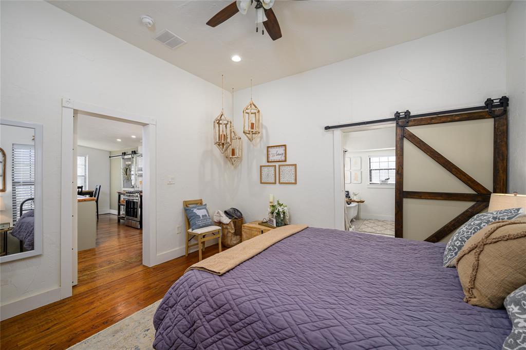 4597 West Line Road Whitesboro, TX 76273 - Photo 20 of 31 a bedroom with a bed and wooden floor