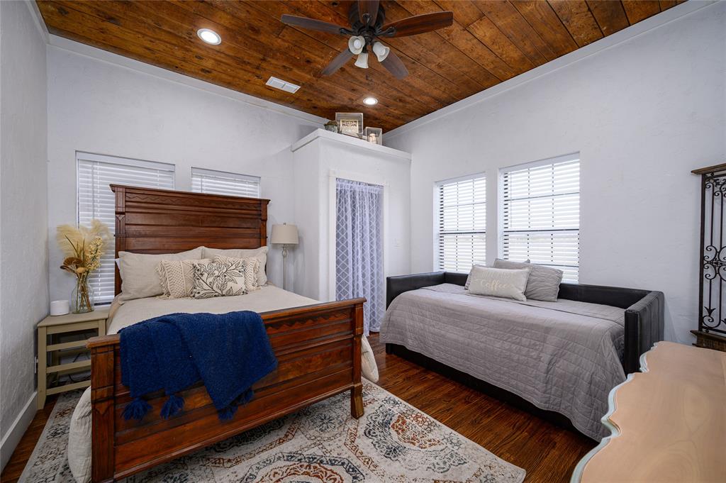 4597 West Line Road Whitesboro, TX 76273 - Photo 23 of 31 a bedroom with a large bed and a chandelier