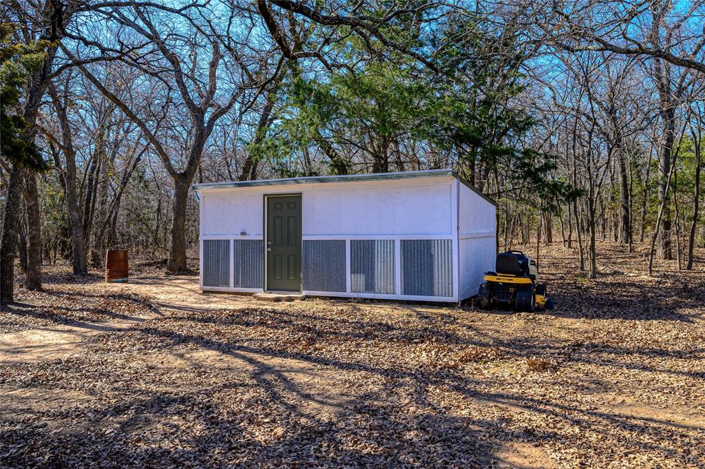 4597 West Line Road Whitesboro, TX 76273 - Photo 27 of 31 a house that has a tree in front of it
