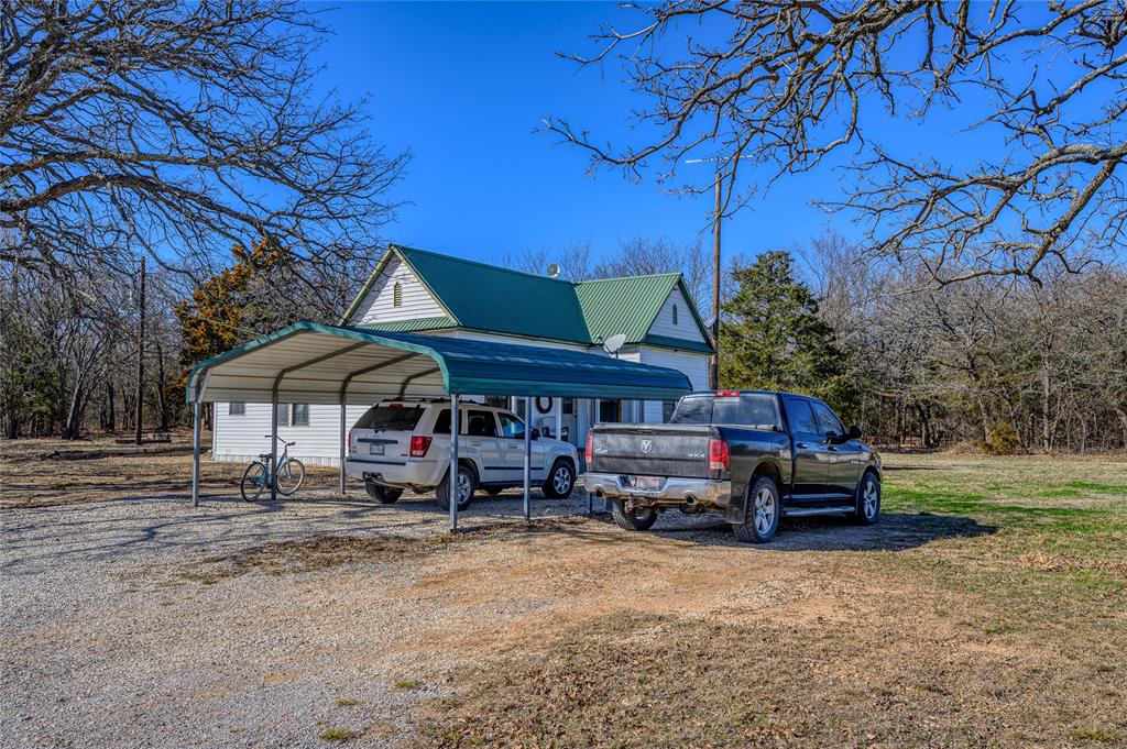 4597 West Line Road Whitesboro, TX 76273 - Photo 3 of 31 a wooden bench sitting in front of a house