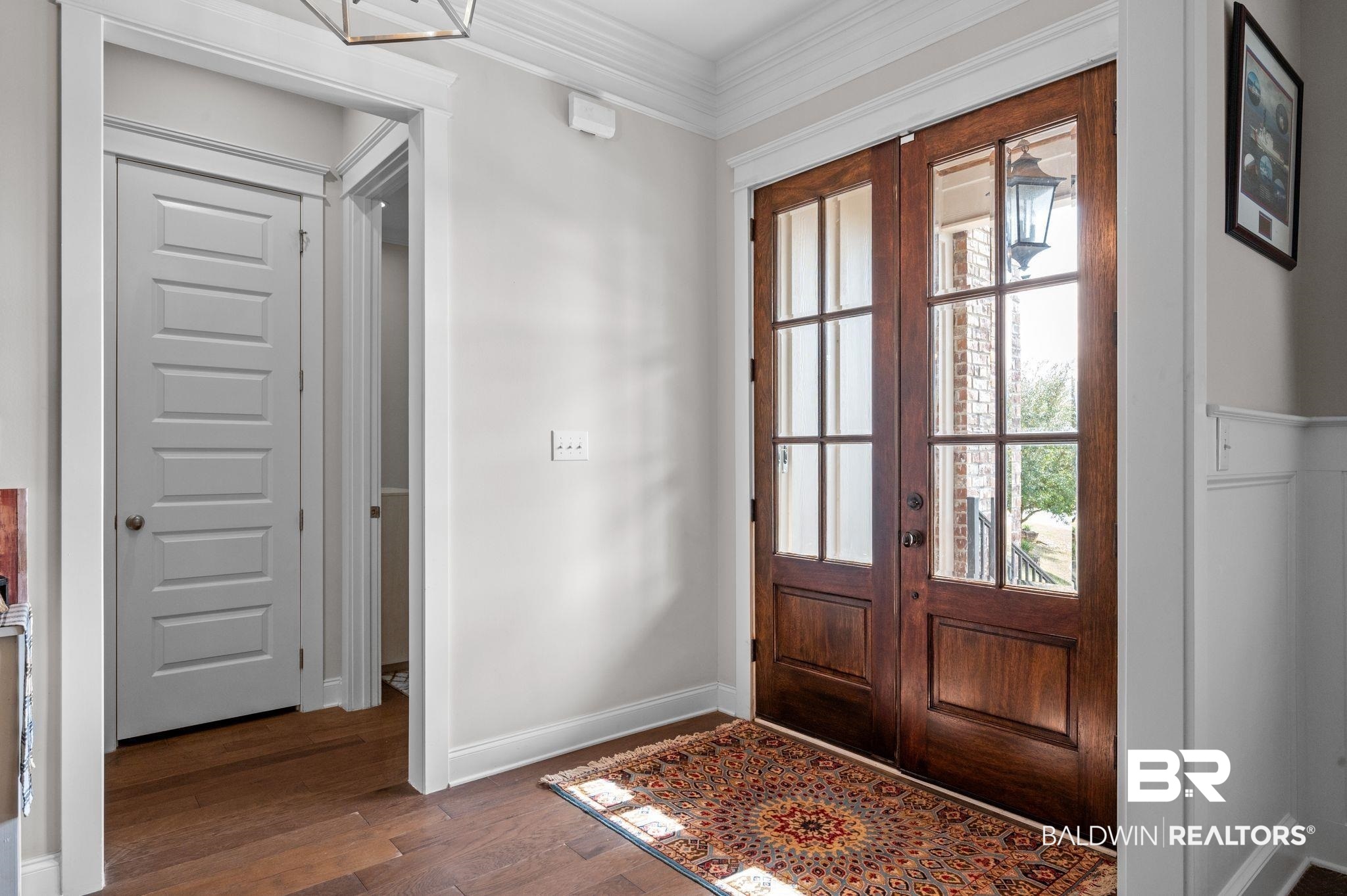 32194 Badger Court Daphne, AL 36527 - Photo 4 of 49 Foyer entrance with ornamental molding, dark wood-style flooring, and french doors