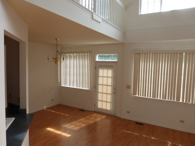 5614 Elizabeth Place, Unit 102 Rolling Meadows, IL 60008 - Photo 2 of 22 a view of an empty room and window