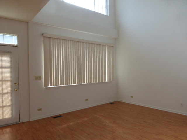 5614 Elizabeth Place, Unit 102 Rolling Meadows, IL 60008 - Photo 3 of 22 an empty room with a window
