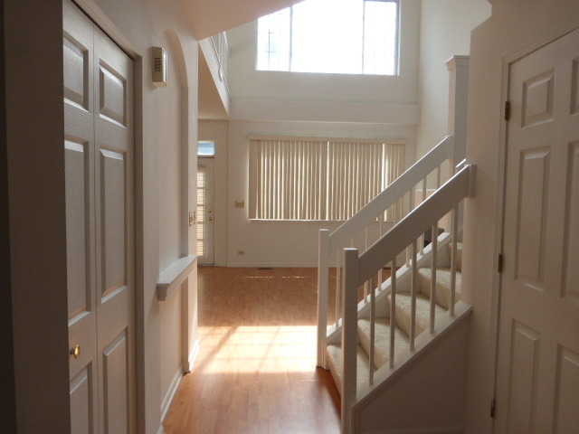 5614 Elizabeth Place, Unit 102 Rolling Meadows, IL 60008 - Photo 5 of 22 a view of staircase with white walls and door