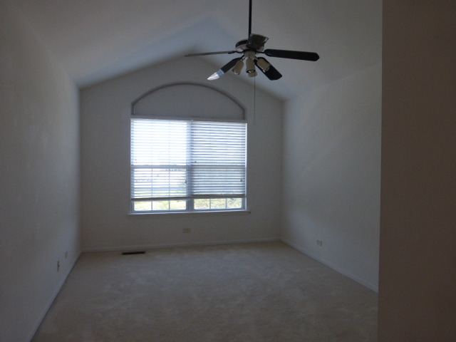 5614 Elizabeth Place, Unit 102 Rolling Meadows, IL 60008 - Photo 10 of 22 an empty room with a window