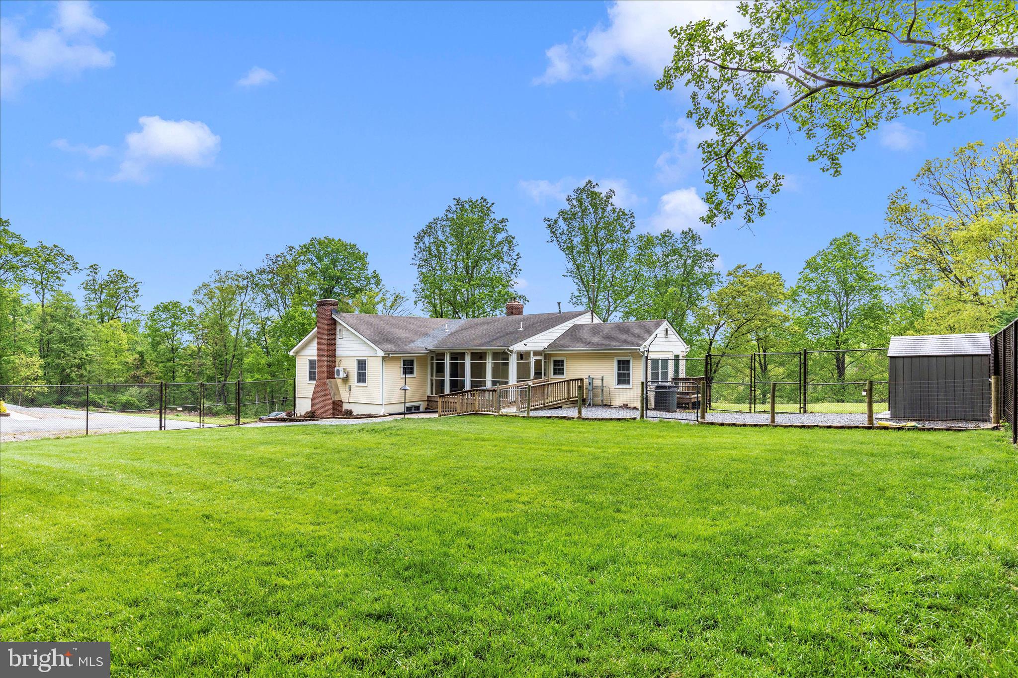 1676 Monument Road Middletown, MD 21769 - Photo 38 of 61 a front view of a house with a yard and trees