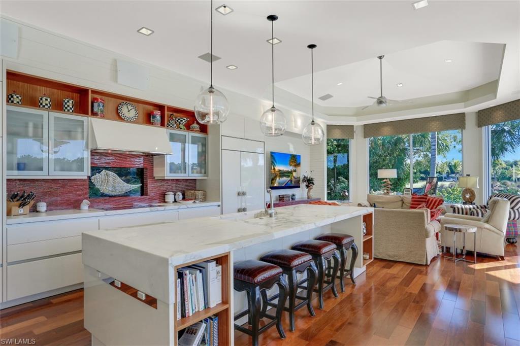2343 Alexander Palm Naples, FL 34105 - Photo 11 of 35 a kitchen with stainless steel appliances granite countertop a stove and refrigerator