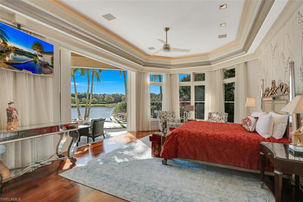 2343 Alexander Palm Naples, FL 34105 - Photo 18 of 35 a bedroom with a bed and large windows