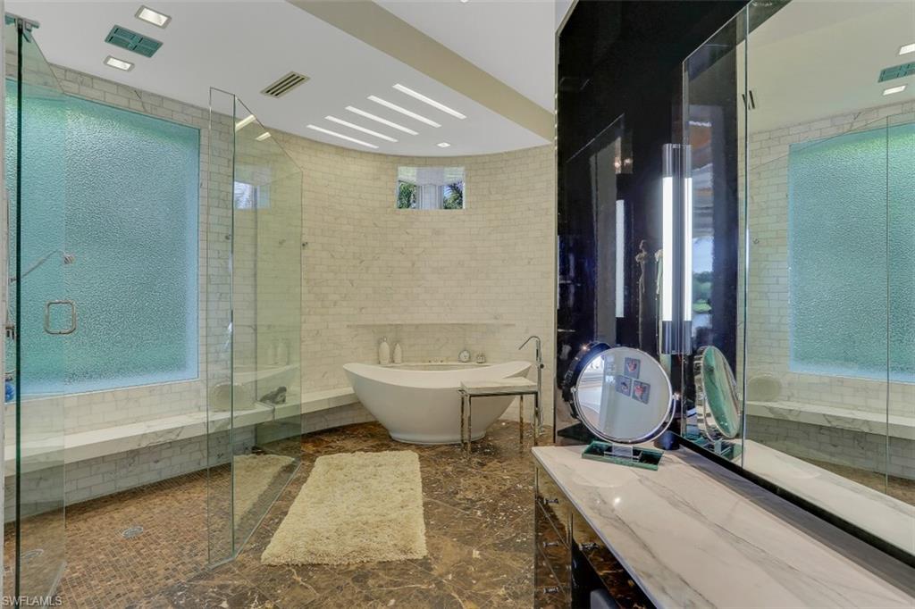 2343 Alexander Palm Naples, FL 34105 - Photo 19 of 35 a bathroom with a sink a toilet and bathtub