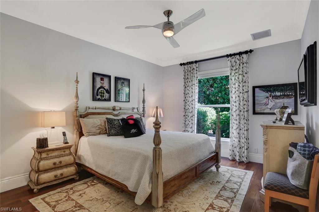 2343 Alexander Palm Naples, FL 34105 - Photo 21 of 35 a bedroom with a bed a window and potted plant