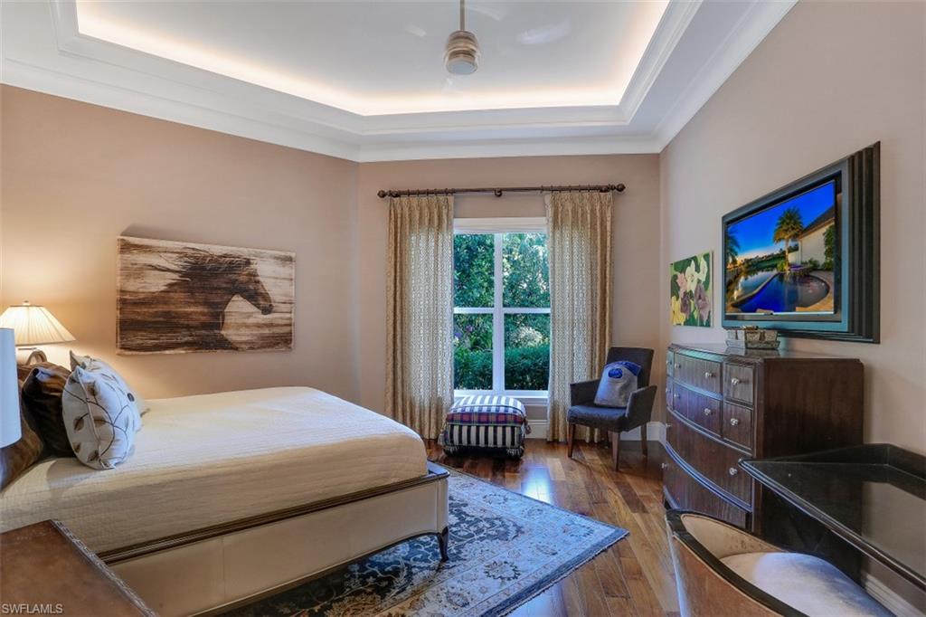 2343 Alexander Palm Naples, FL 34105 - Photo 23 of 35 a bedroom with a bed a dresser next to a window