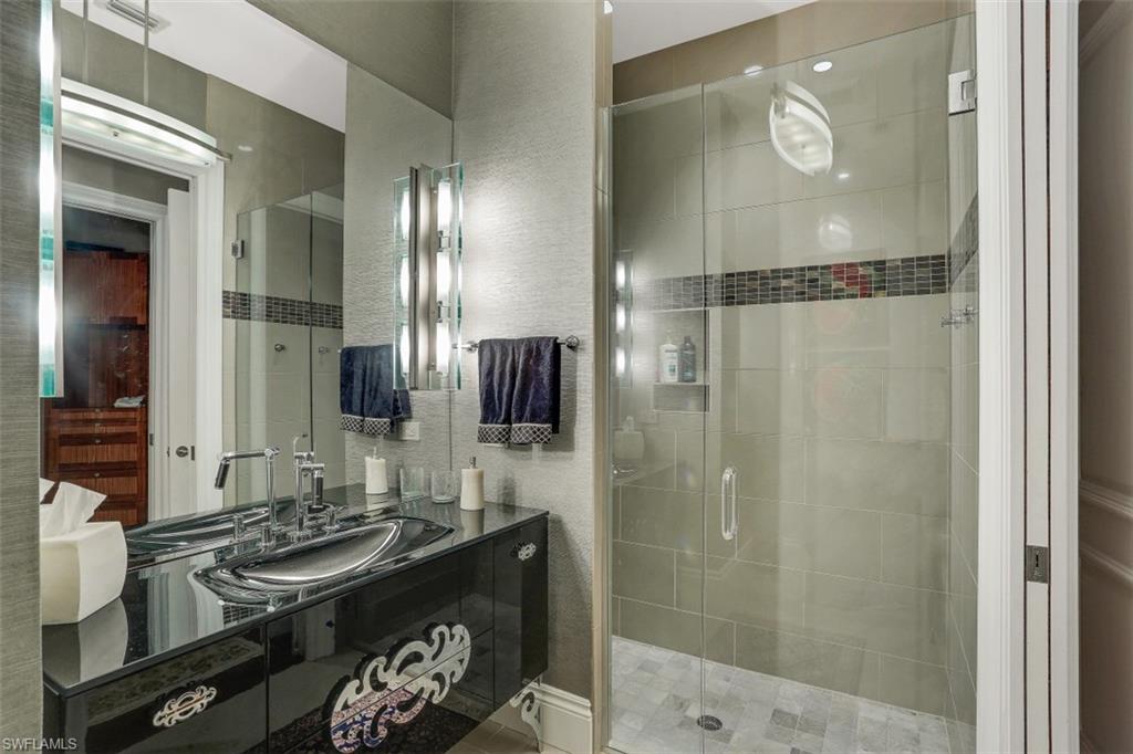 2343 Alexander Palm Naples, FL 34105 - Photo 24 of 35 a bathroom with a mirror and a shower
