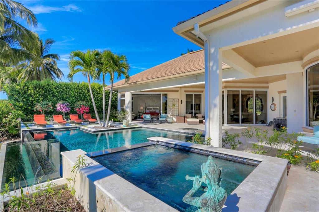 2343 Alexander Palm Naples, FL 34105 - Photo 28 of 35 a view of house with swimming pool and furniture