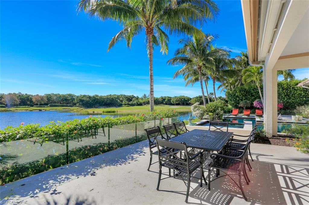 2343 Alexander Palm Naples, FL 34105 - Photo 30 of 35 a view of a lake with furniture and a yard