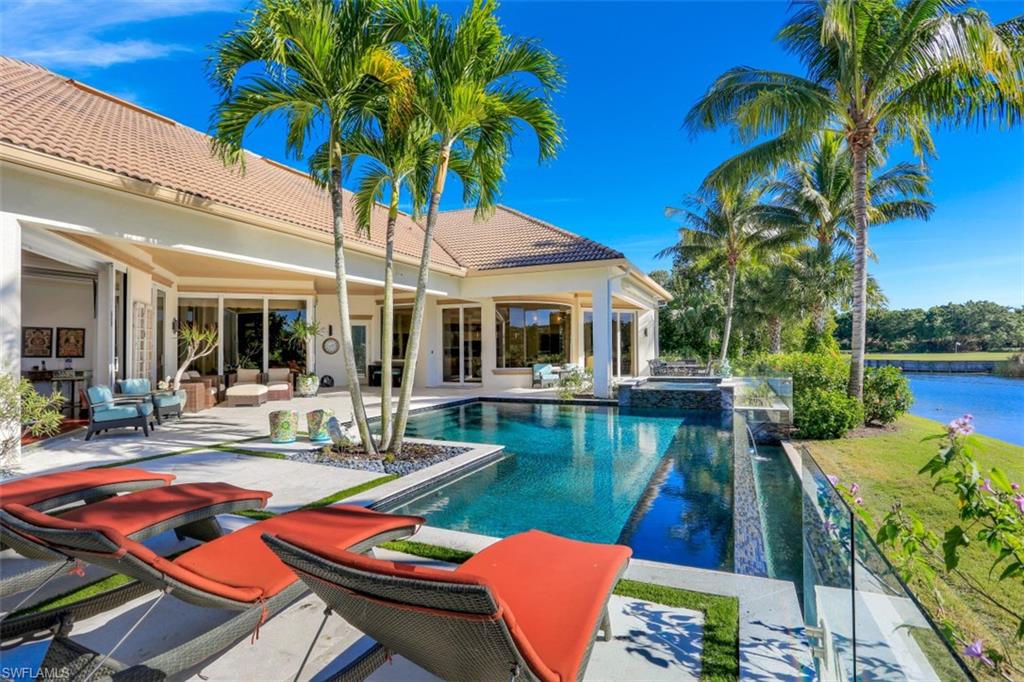 2343 Alexander Palm Naples, FL 34105 - Photo 32 of 35 a view of house with swimming pool outdoor seating and yard
