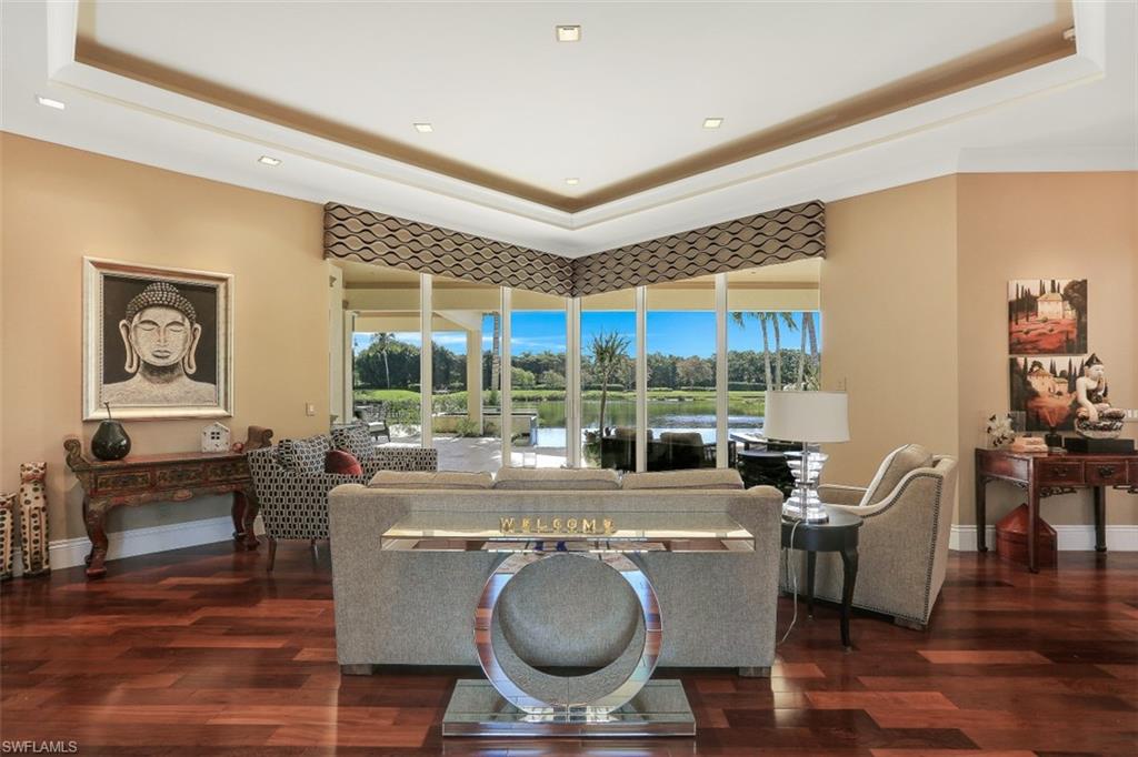 2343 Alexander Palm Naples, FL 34105 - Photo 5 of 35 a living room with furniture a large window and wooden floor