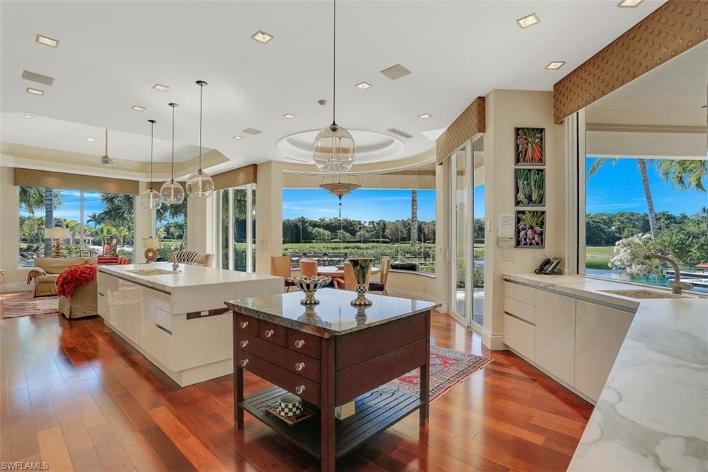 2343 Alexander Palm Naples, FL 34105 - Photo 9 of 35 a large living room with stainless steel appliances granite countertop a couch and a large window