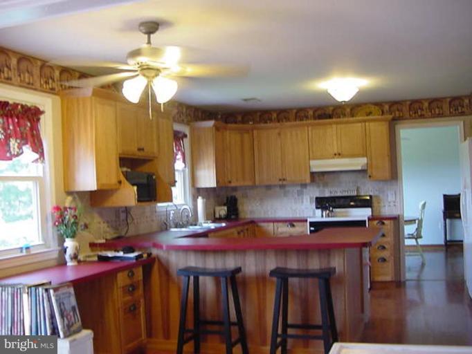 6353 Old Bust Head Road Warrenton, VA 20187 - Photo 11 of 13 a kitchen with a stove a sink and cabinets