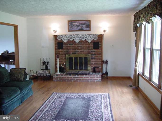 6353 Old Bust Head Road Warrenton, VA 20187 - Photo 8 of 13 a living room with furniture and a fireplace