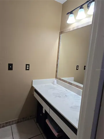 a bathroom with a sink and vanity