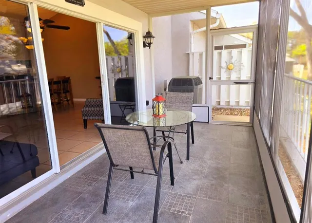 a dining room with furniture and a floor to ceiling window