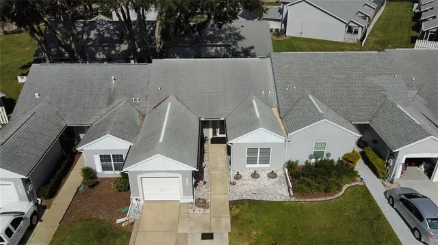 an aerial view of a house with a yard