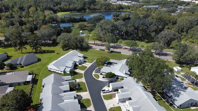 an aerial view of a house with outdoor space pool patio lake and lake view