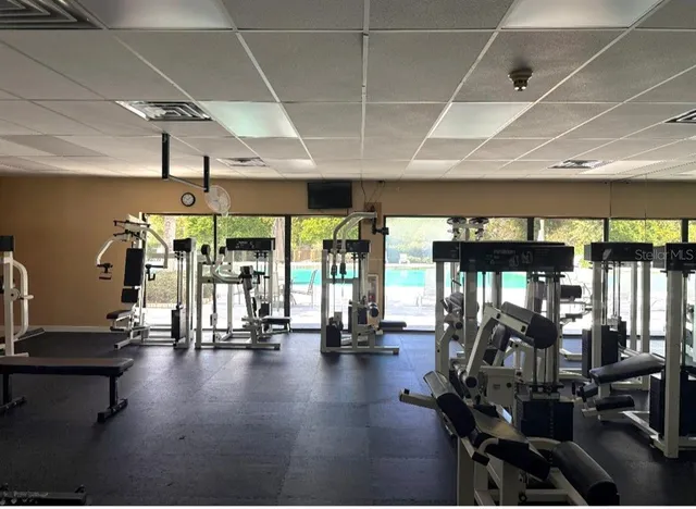 a gym room with lots of gym equipment