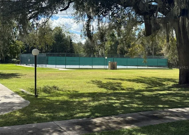 a view of a large swimming pool with a yard