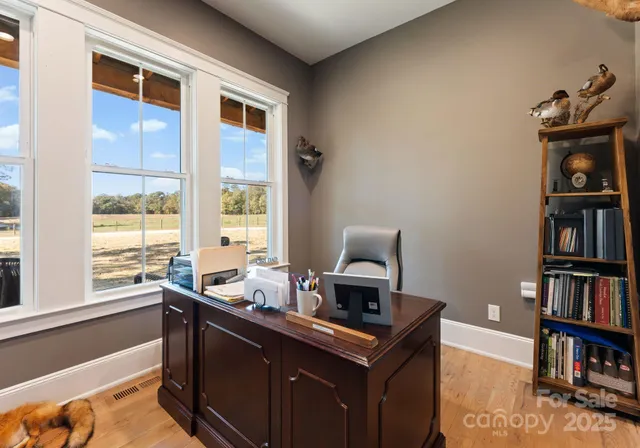 a living room with furniture and a book shelf