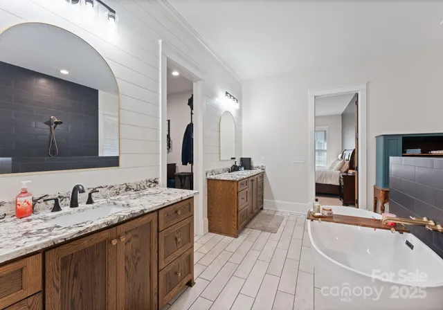 a bathroom with a sink double vanity granite and a large mirror